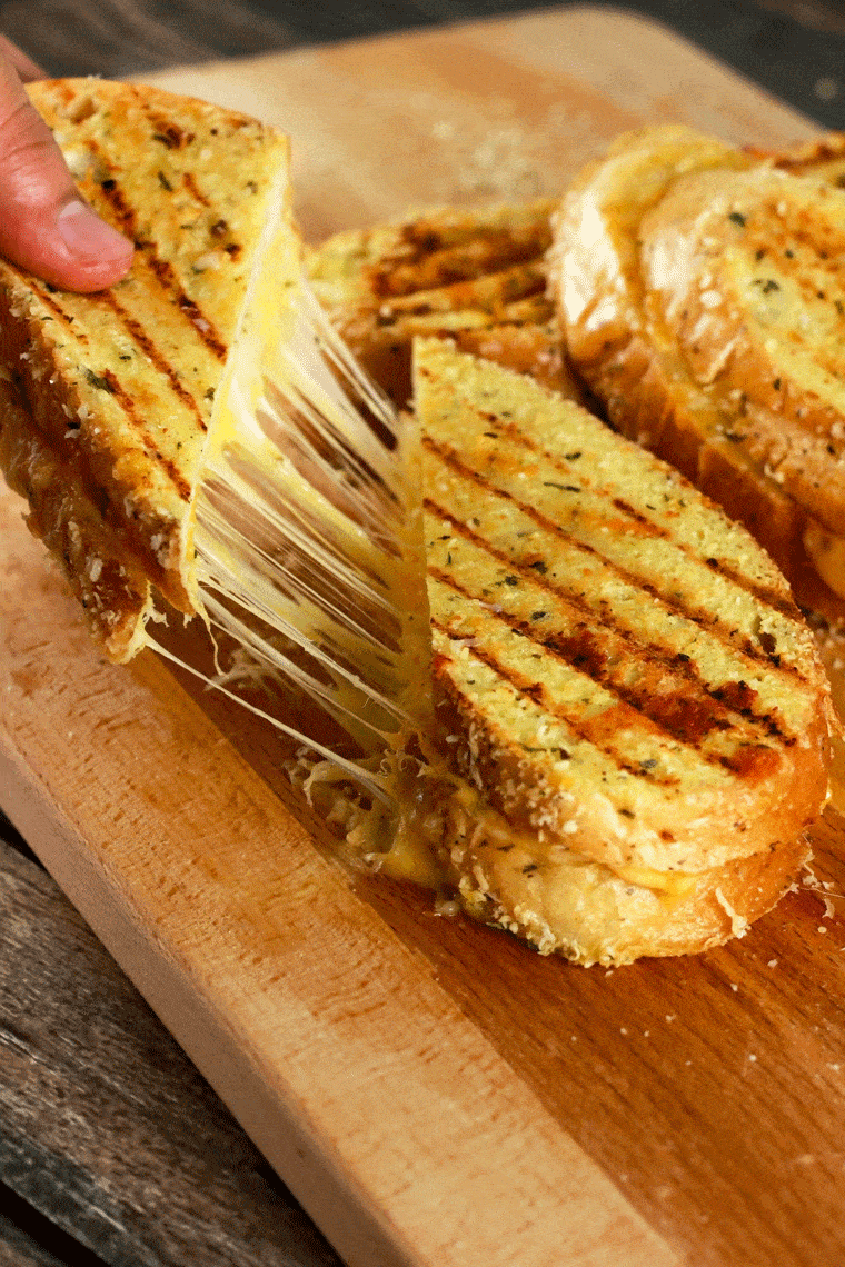 Grilled Cheese Sandwich with Garlic Parmesan Topping - This grilled cheese sandwich is going to quickly become your absolute favorite! It's SUPER easy to make and the topping stores really well! Prepare the topping ahead of time and whip this up in 5 minutes! The kids are going to LOVE this! | ScrambledChefs.com