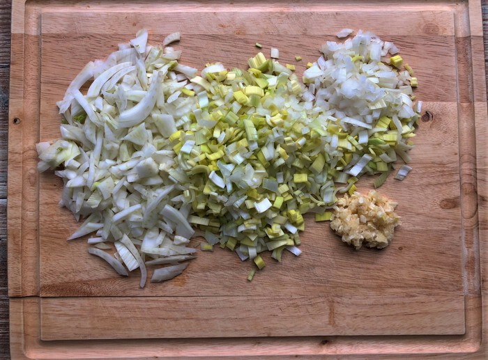 Mincing vegetables on cutting board