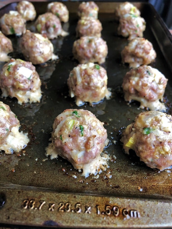 Meatballs removed from the oven on baking sheet