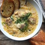 Bowl of Italian wedding soup with bread