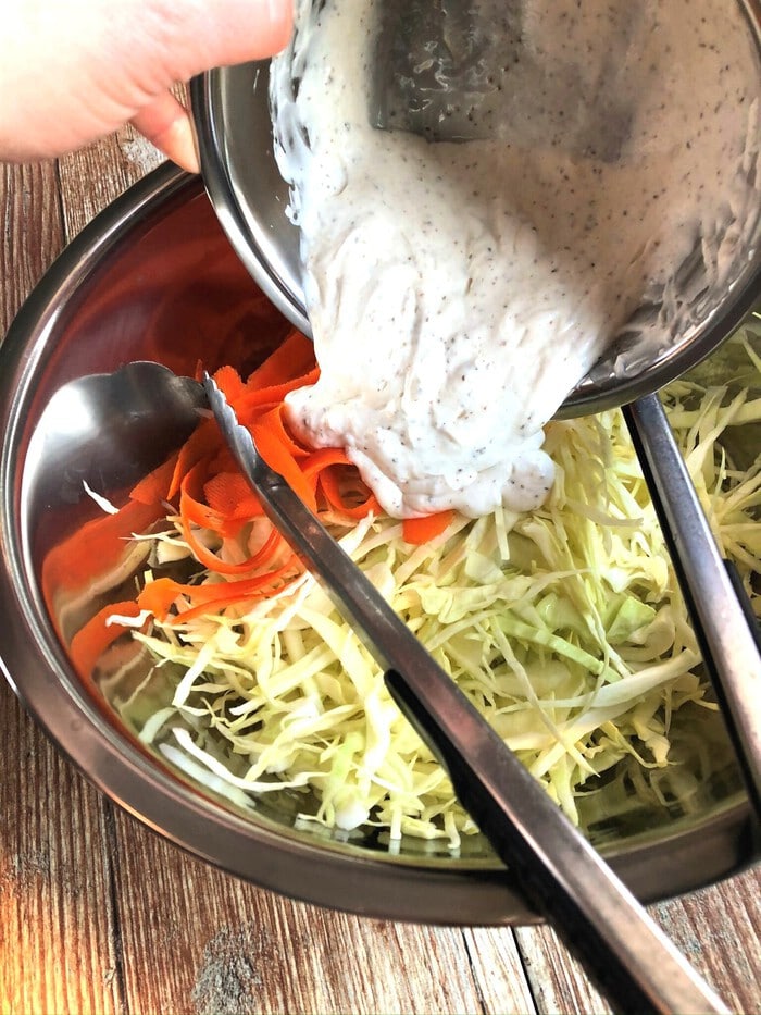 Mixing dressing into vegetables for cole slaw