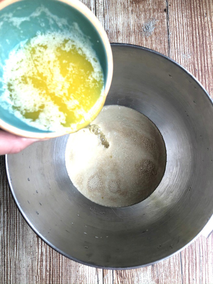 Adding butter to yeast mixture