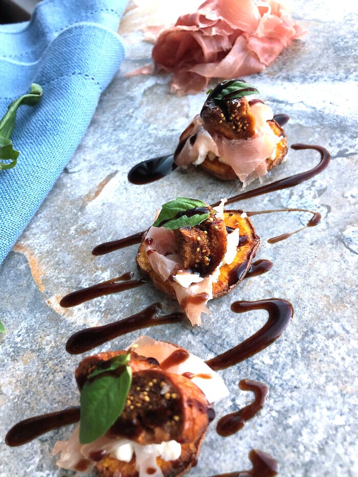 Sweet potato crostini topped with prociutti and figs