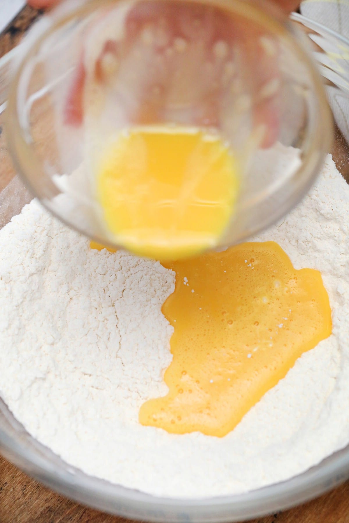 Adding eggs to flour