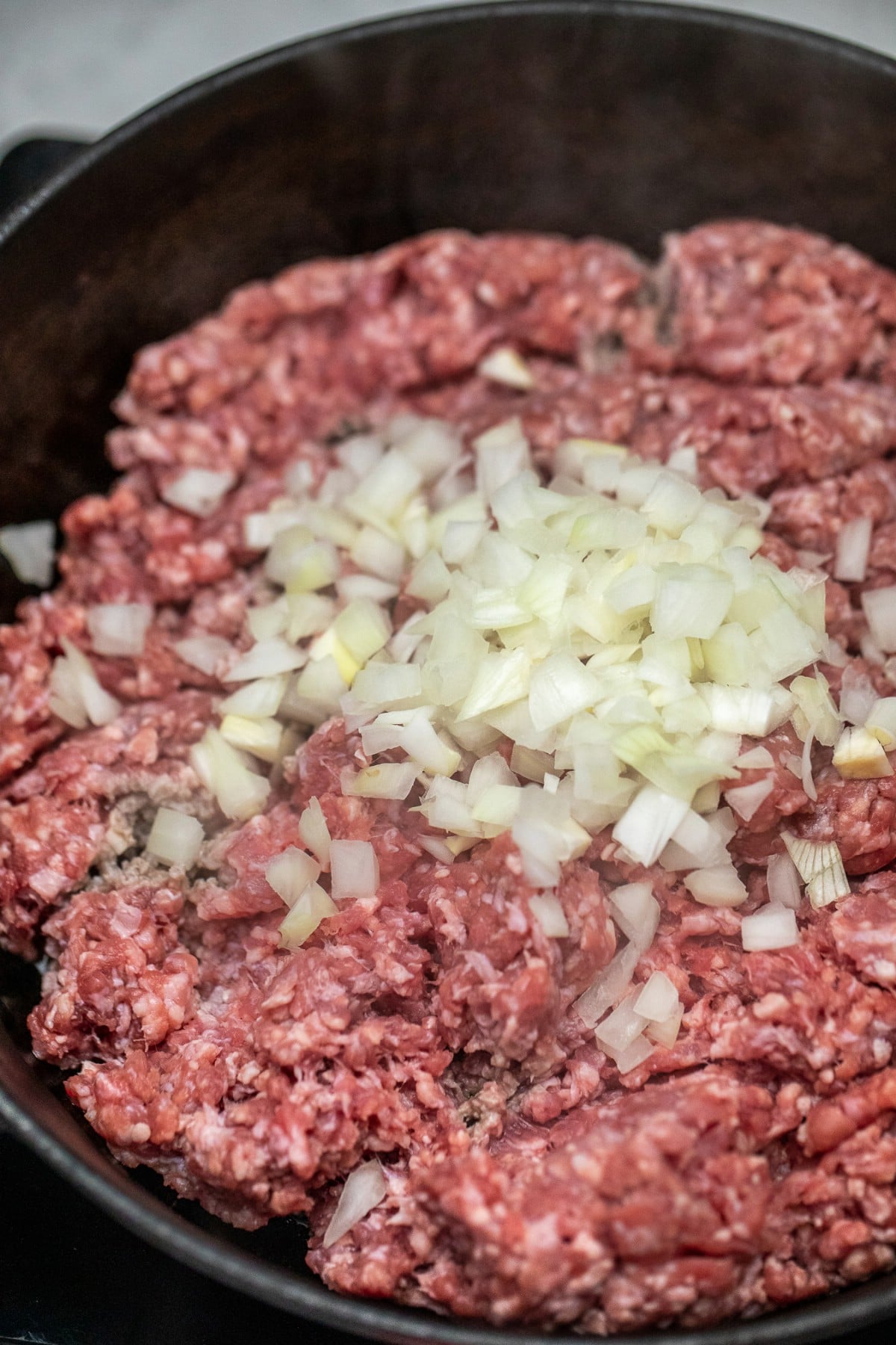 Ground beef and onions in skillet