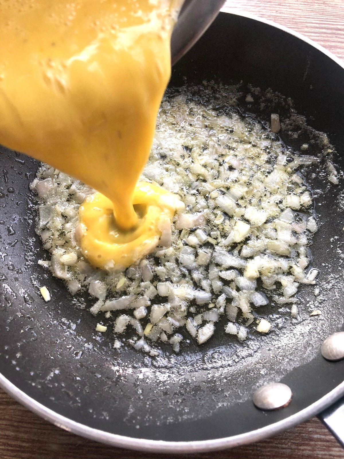 Adding eggs to skillet