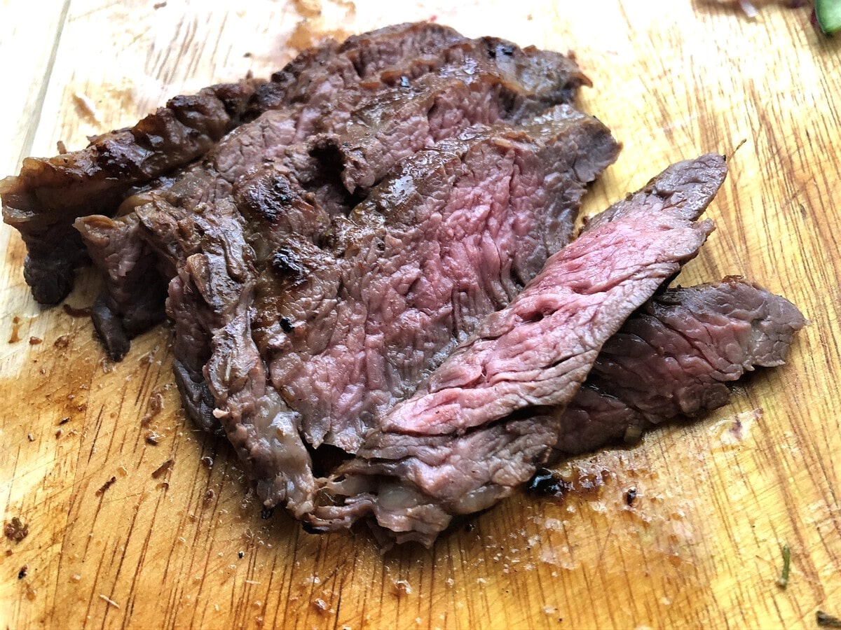 Sliced steak on cutting board