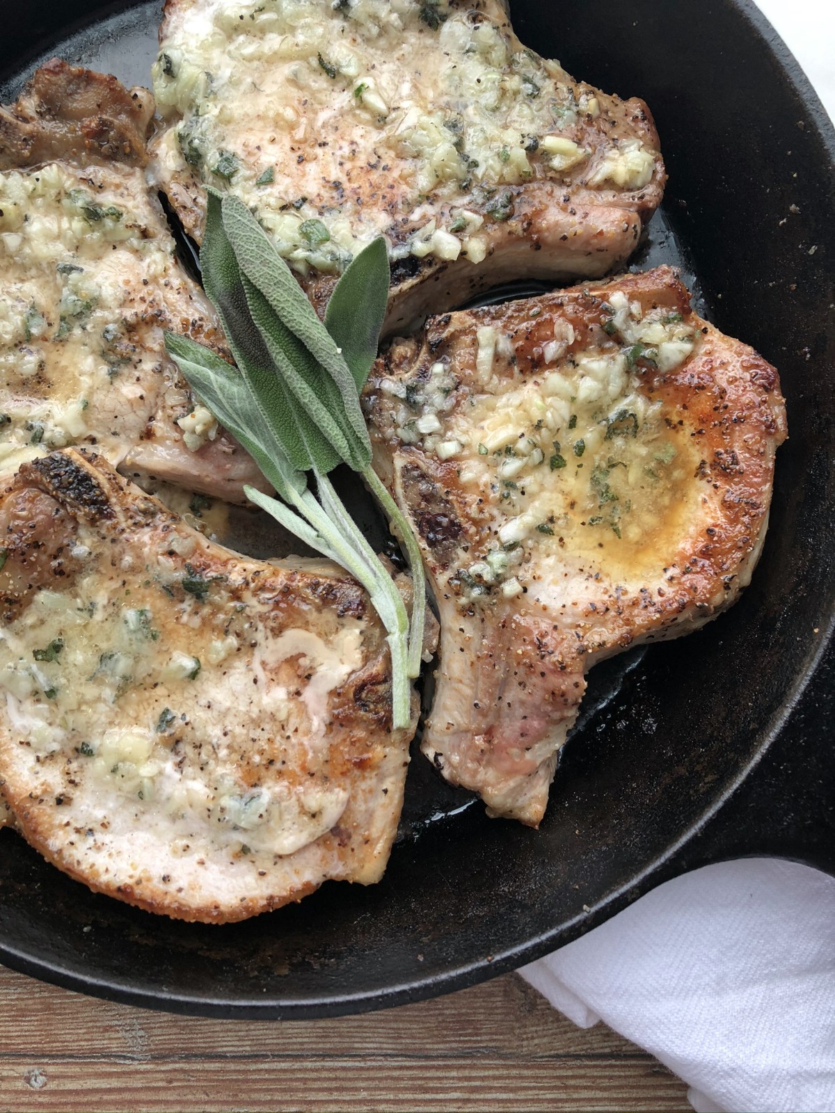 Seared baked pork chops in cast iron skillet