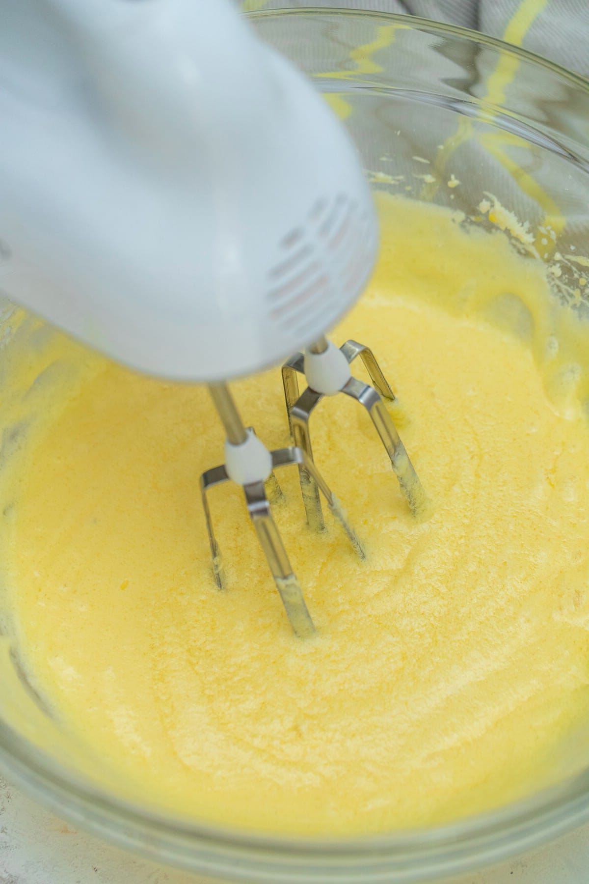 Mixer in bowl with butter and sugar mixture