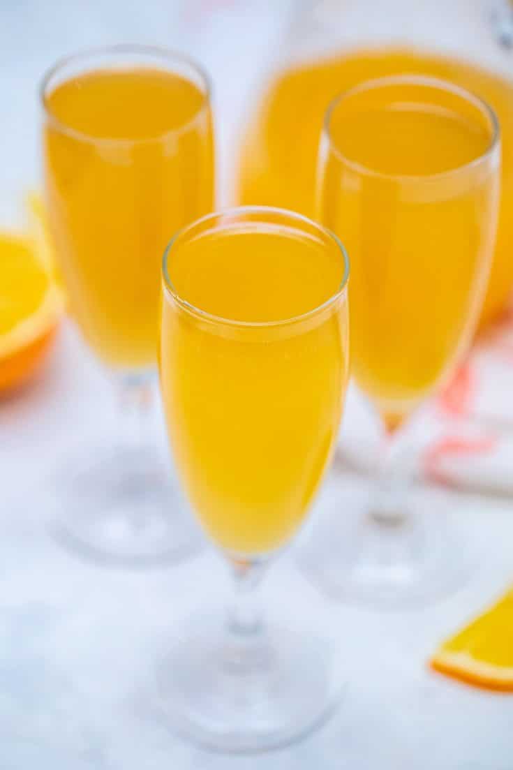 Champagne flutes filled with mimosa