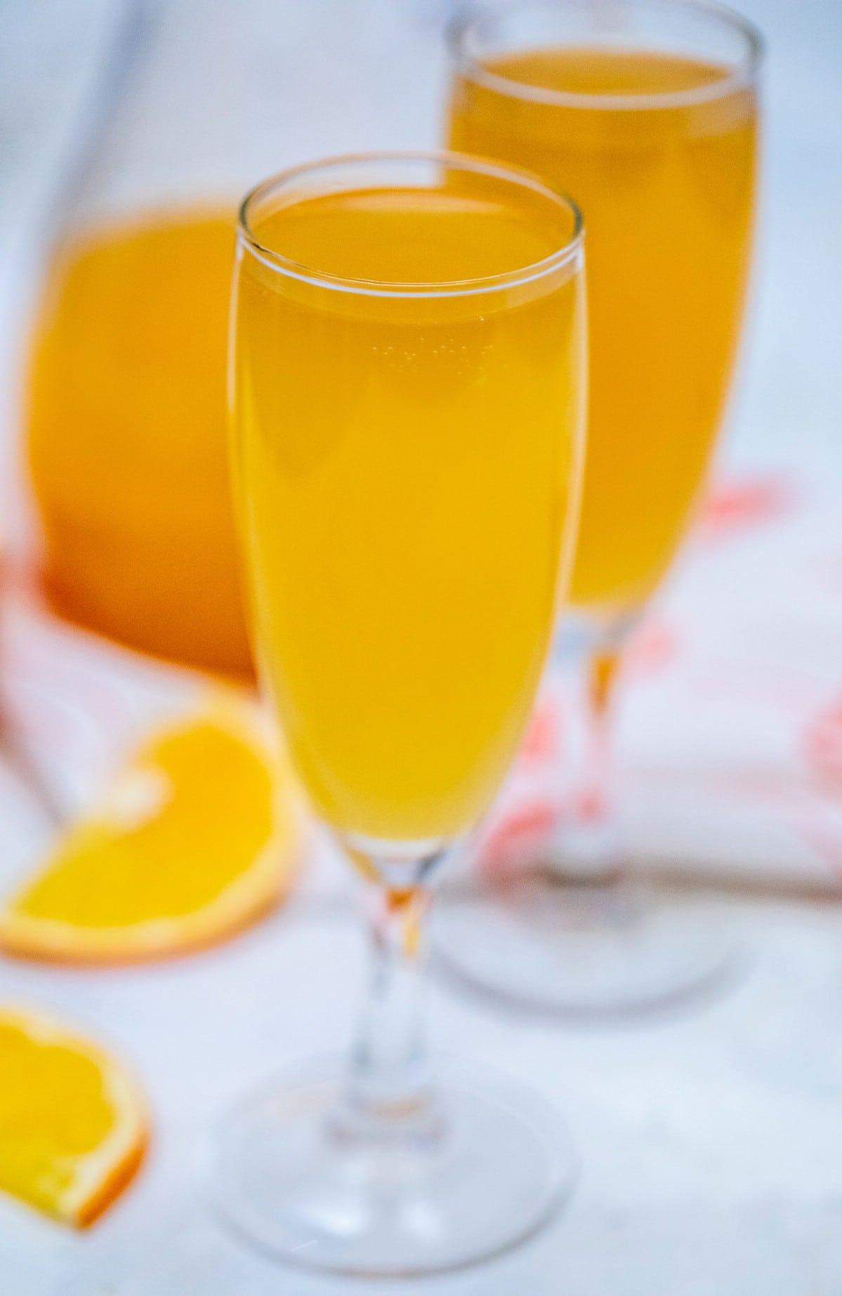 Champagne flutes filled with mimosa