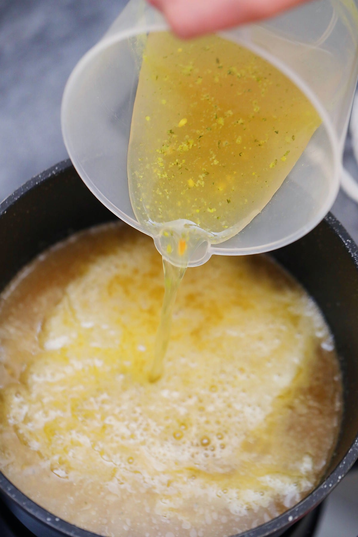 Pouring broth into pan