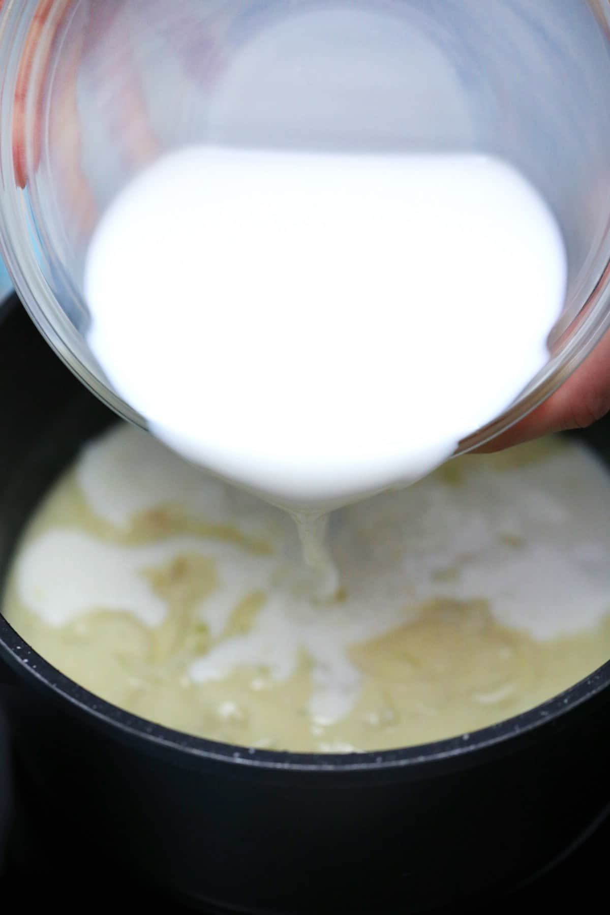 Pouring milk into skillet