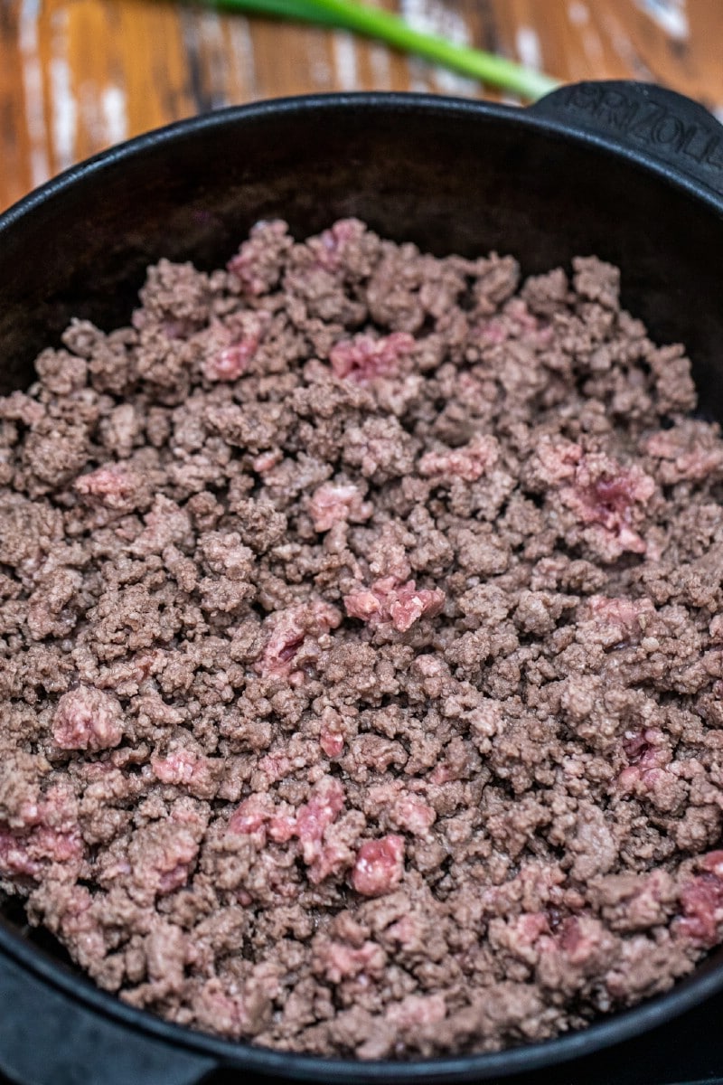 Ground beef being cooked in cast iron skilet