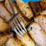 Sliced pork chops with fork spearing a piece