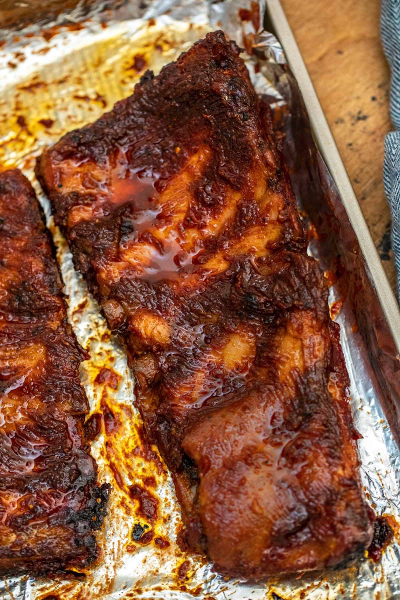 Slab of barbecue ribs on baking sheet