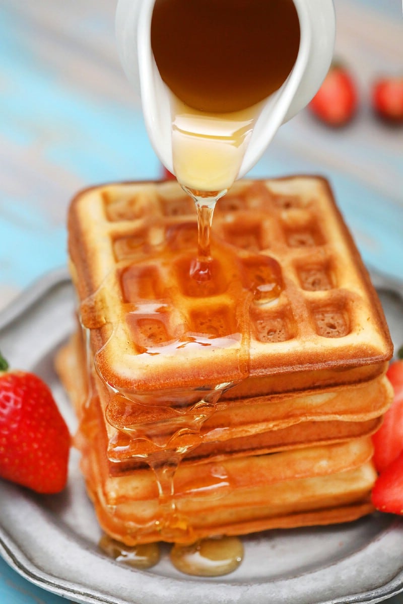 Pouring syrup on waffles