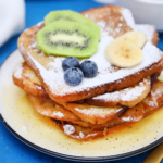 Stack of french toast on yellow plate