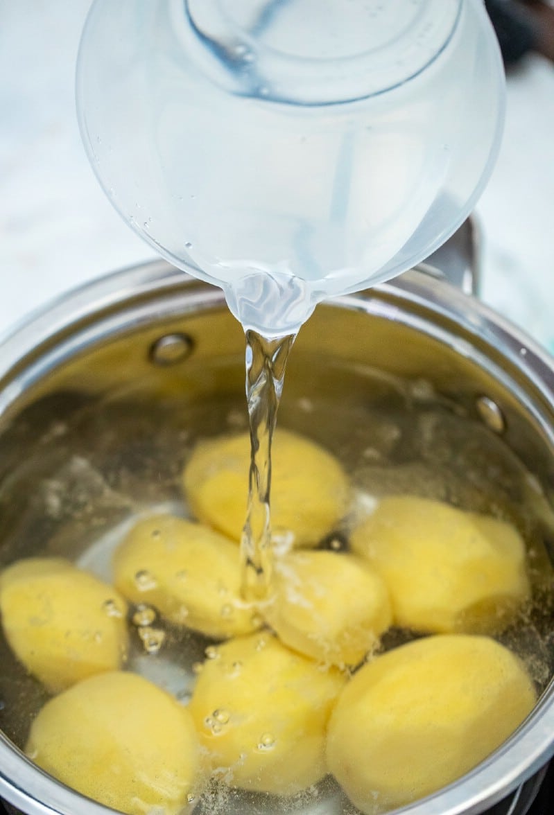 Pouring water over potatoes