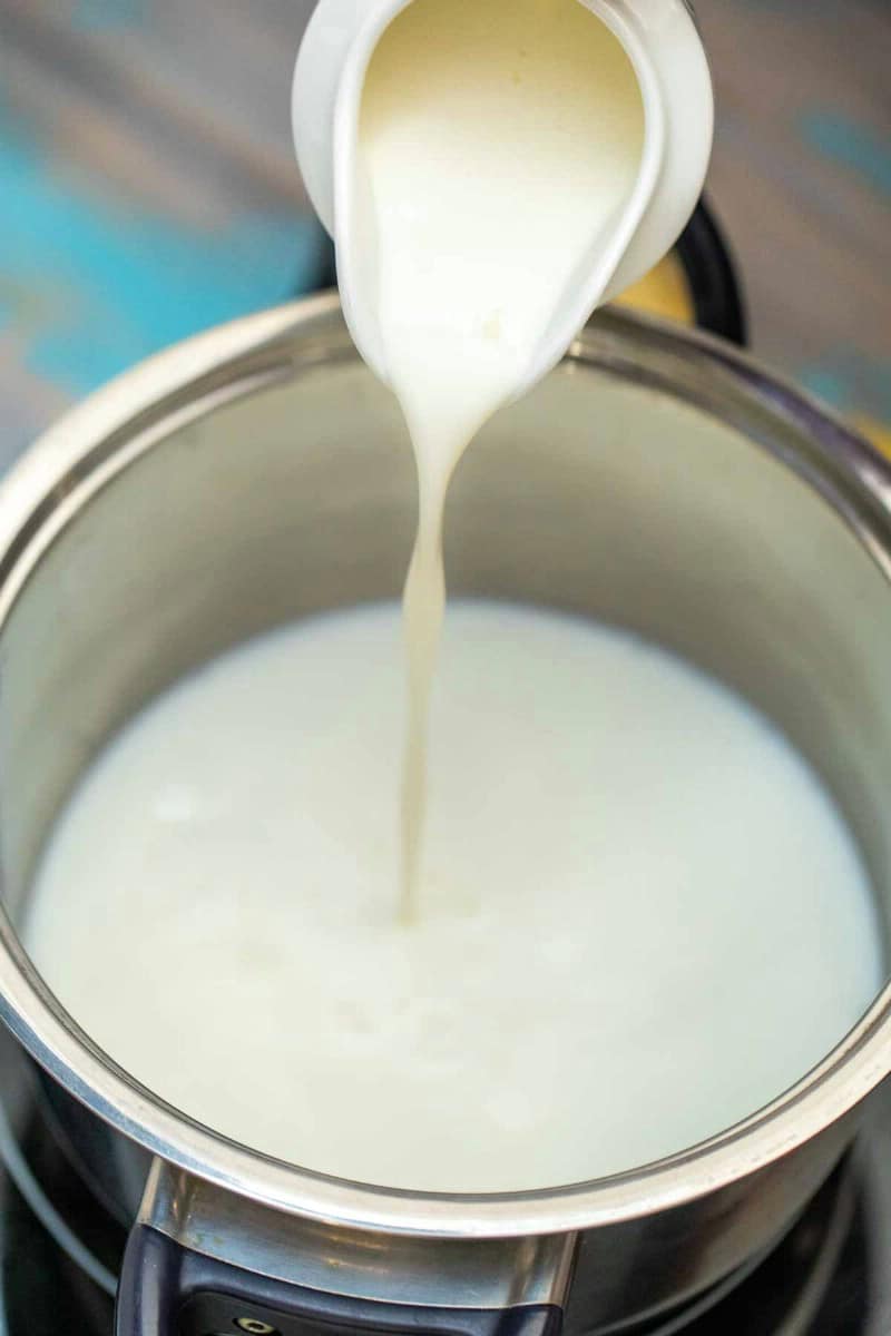 Pouring milk into stockpot