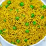 White bowl of Indian rice with peas