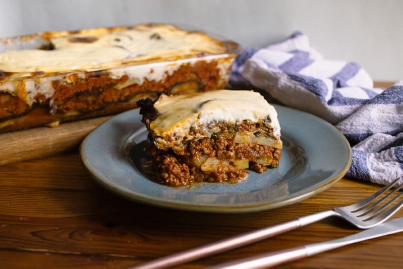 Beef moussaka casserole slice on teal plate