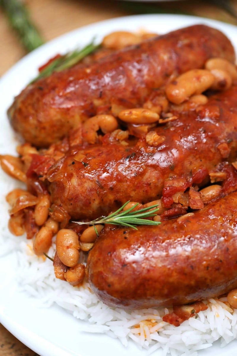 Pork sausage and beans on white plate