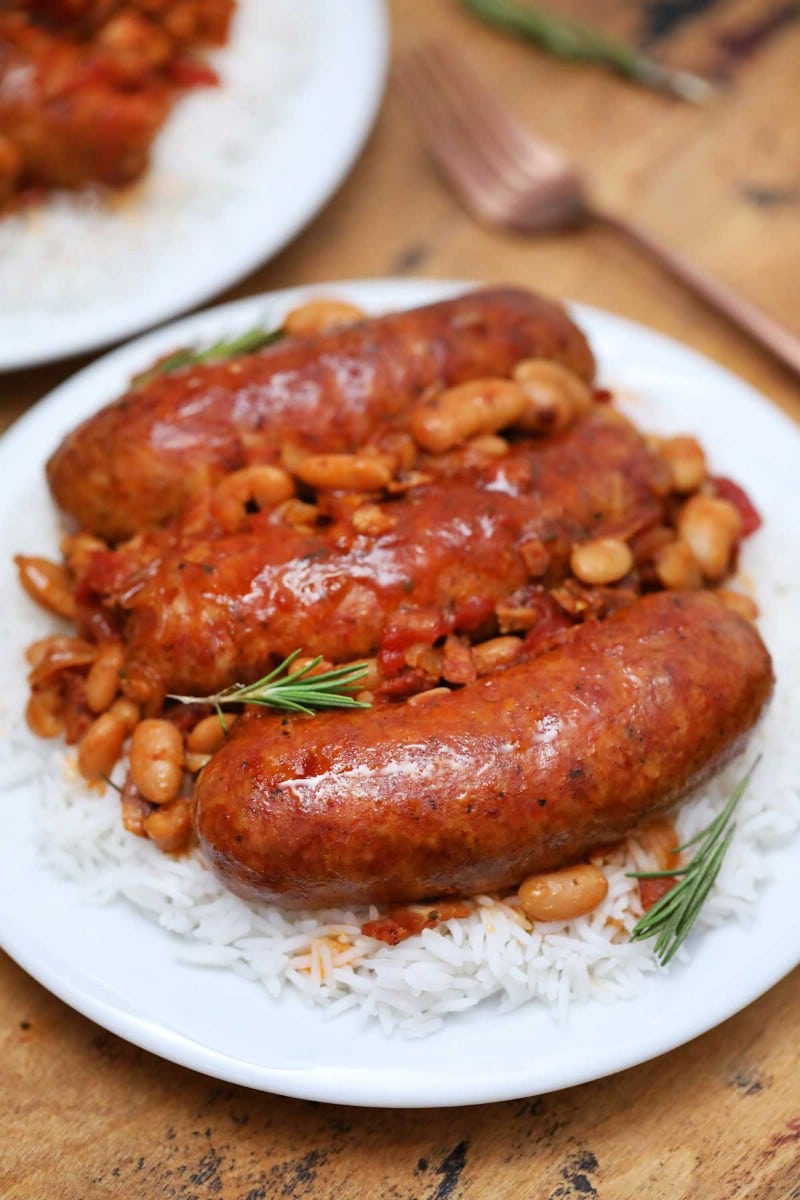 Pork sausage and beans on white plate