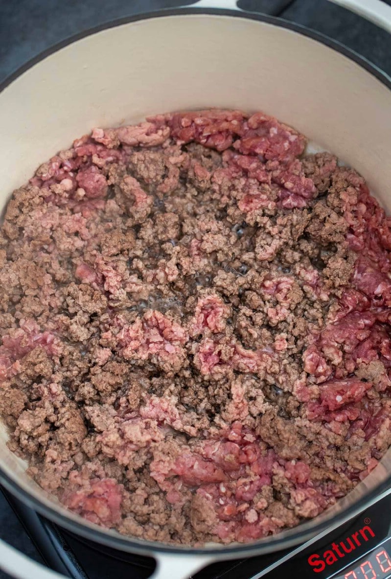 Ground beef cooking in dutch oven