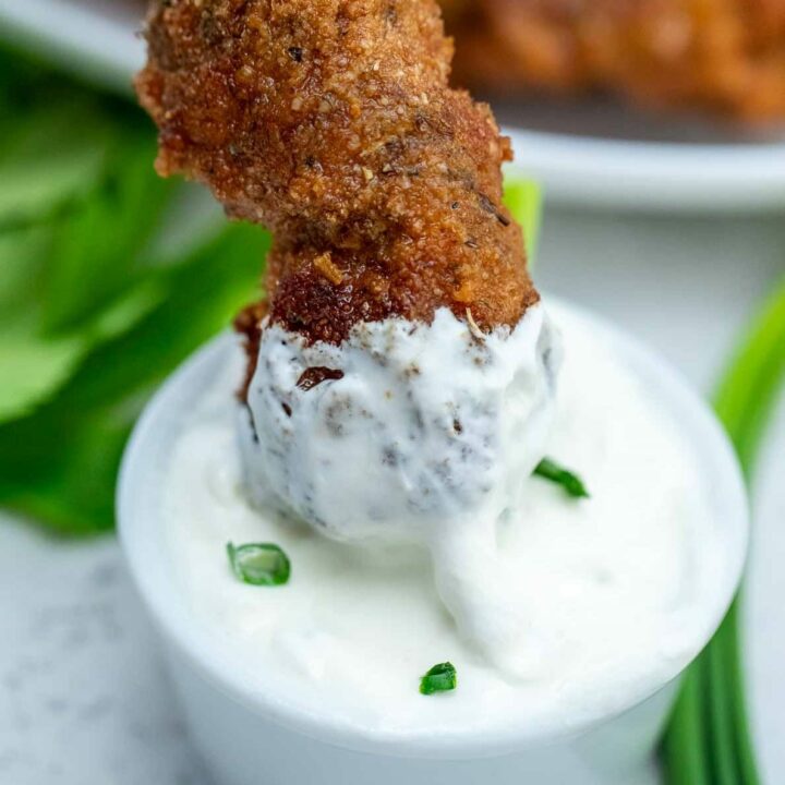 Dipping city chicken into creamy sauce