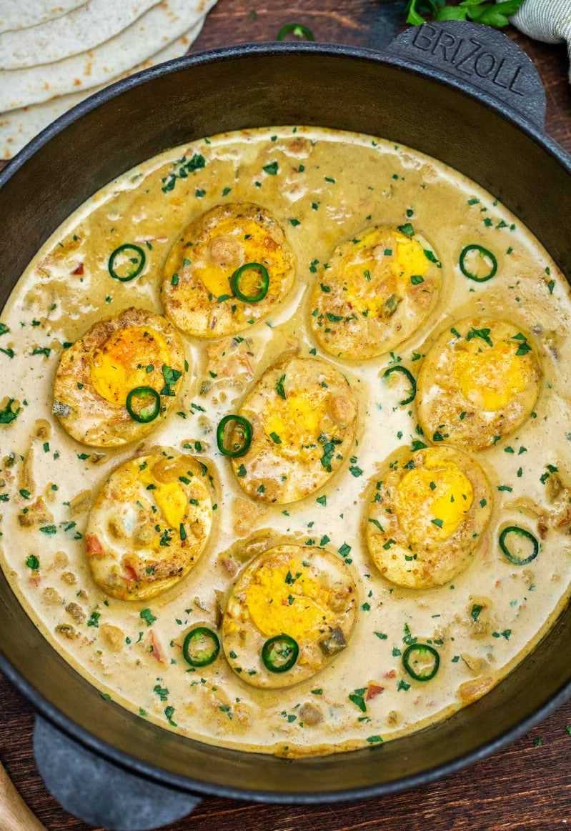 Eggs in curry sauce in cast iron skillet