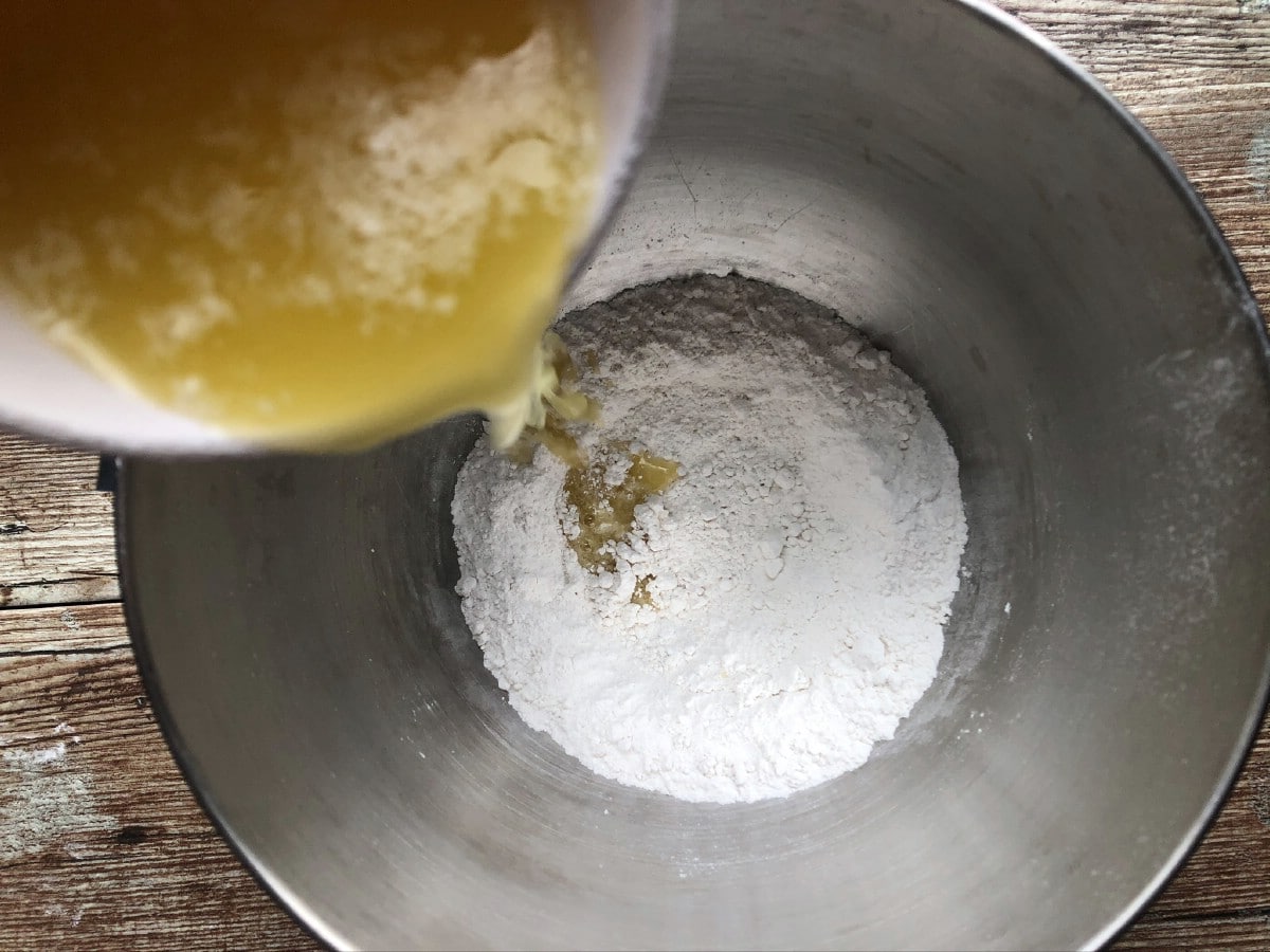 Pouring butter into flour
