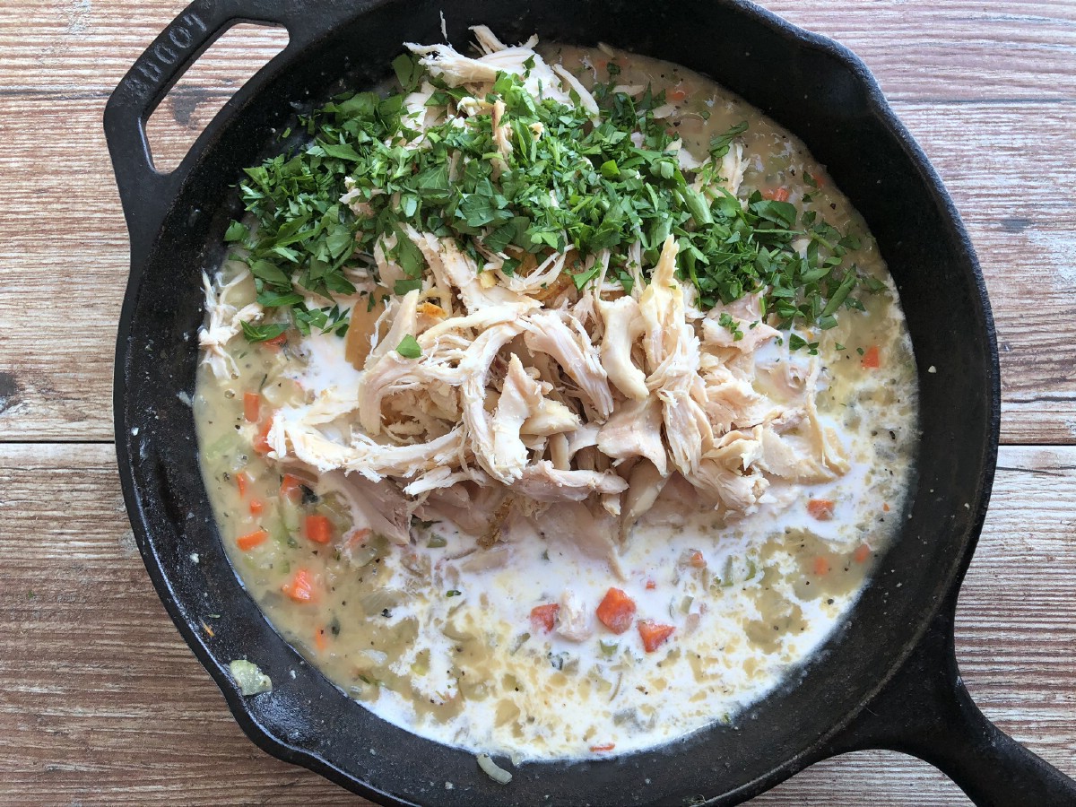 Adding chicken and herbs to skillet