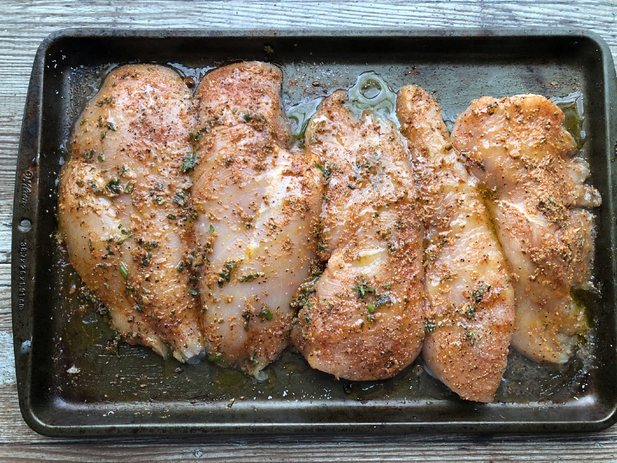 Seasoned chicken on baking sheet