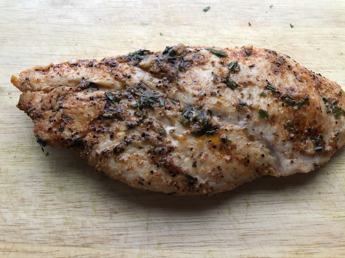 Chicken breast cooked on cutting board