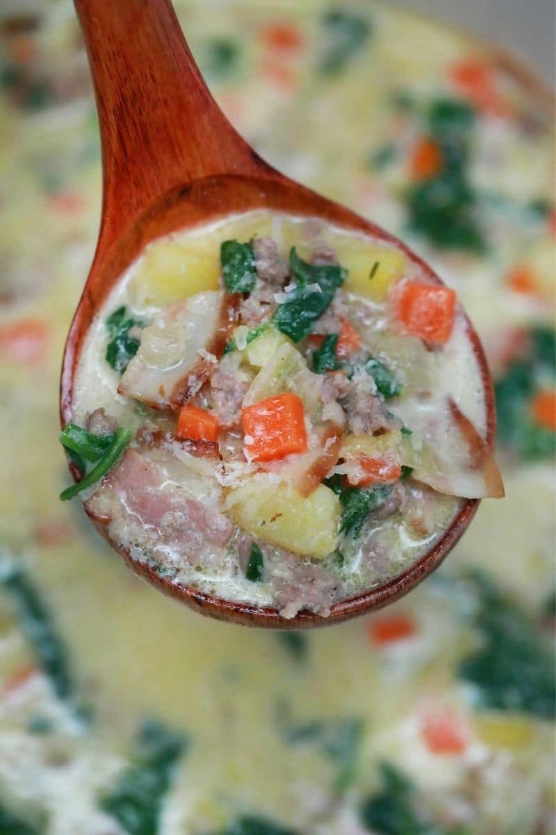 Wooden spoon of zuppa toscana soup