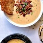 White bowl of bacon cheddar beer cheese soup