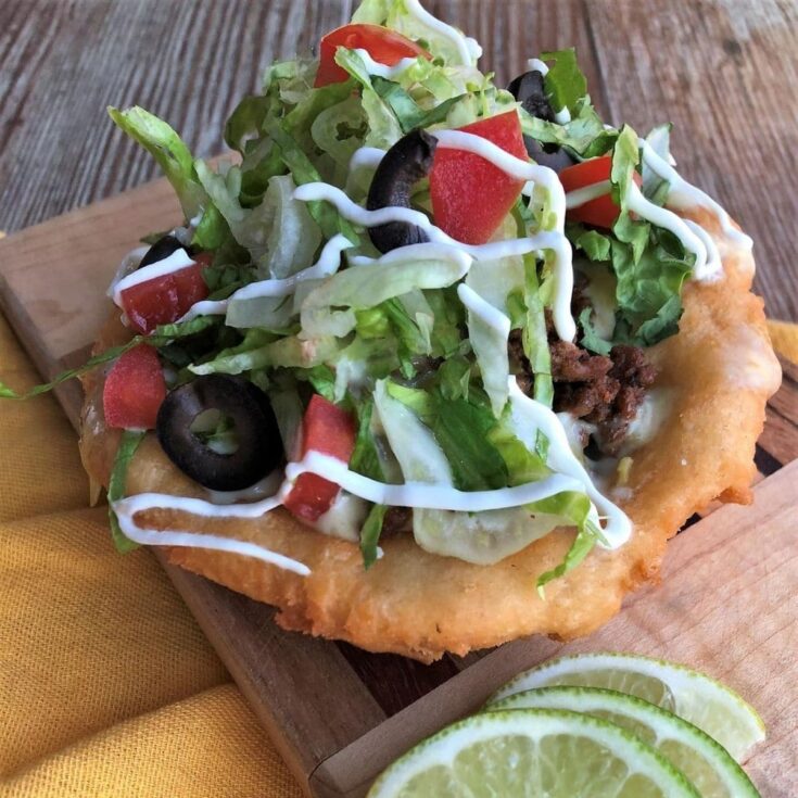 Fry bread taco with lettuce and tomato