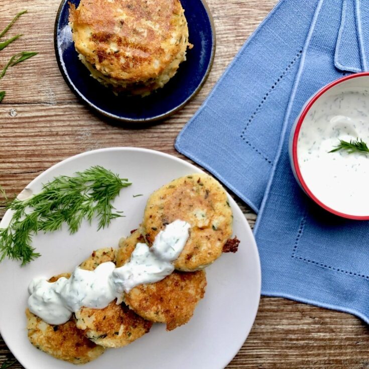 Potato cakes on plate with dill sauce