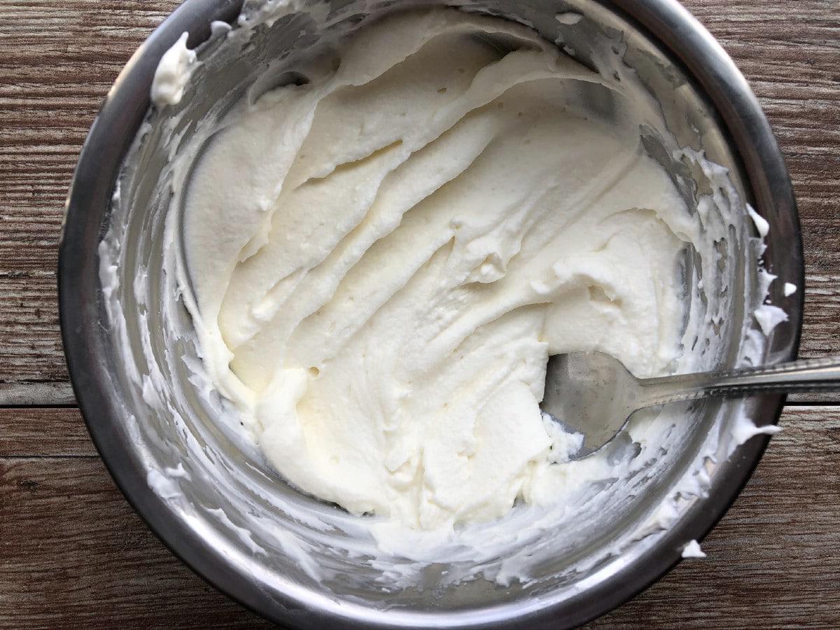 Whipped cream in stainless steel bowl