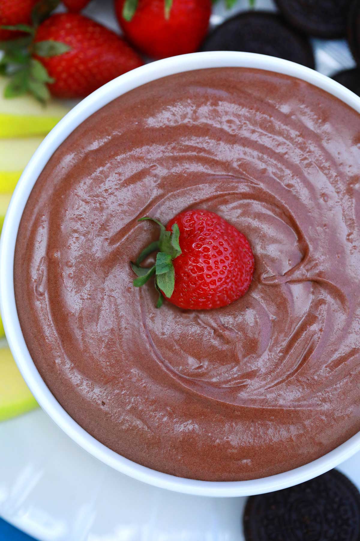 Chocolate dessert dip in bowl with strawberry