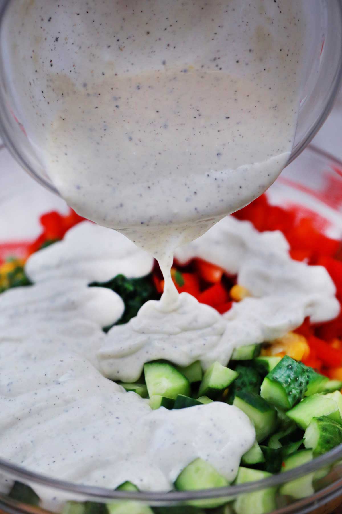 Pouring dressing over salad