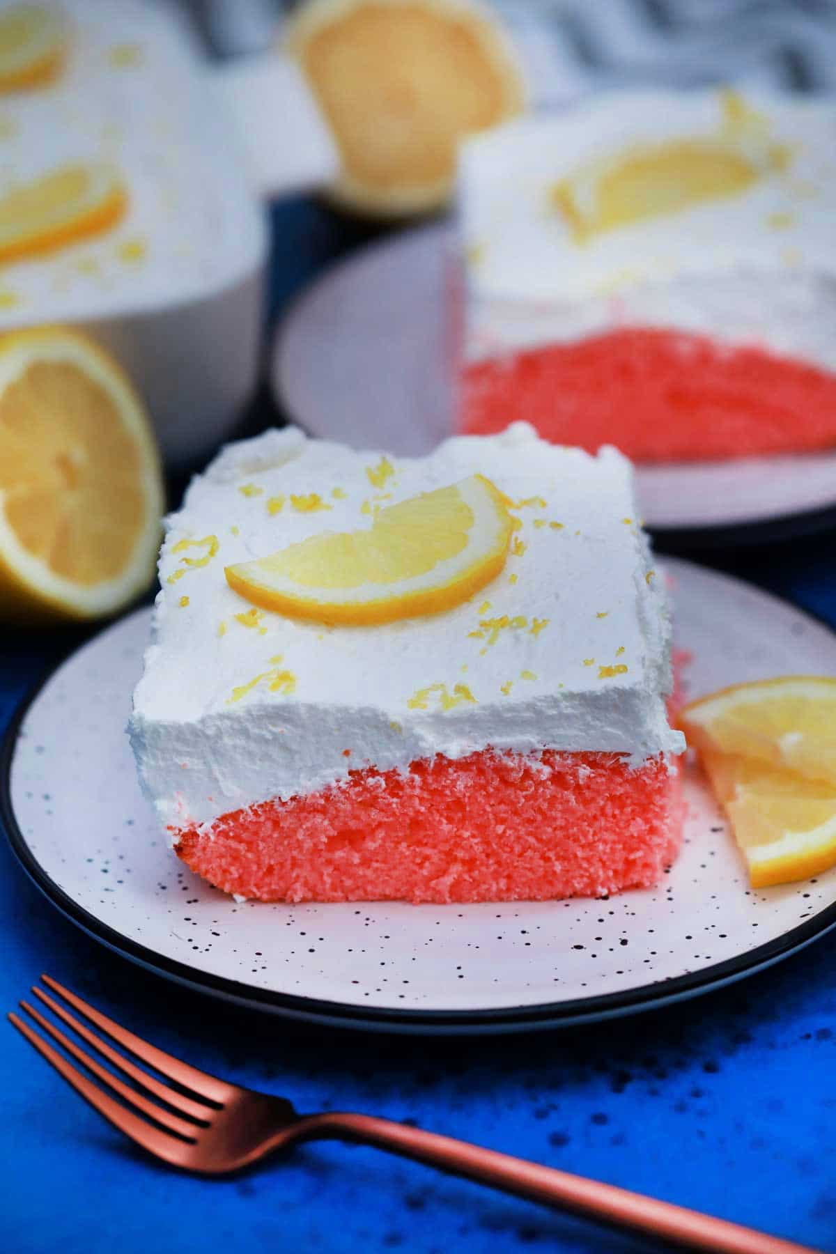 Slice of pink lemonade cake on white plate