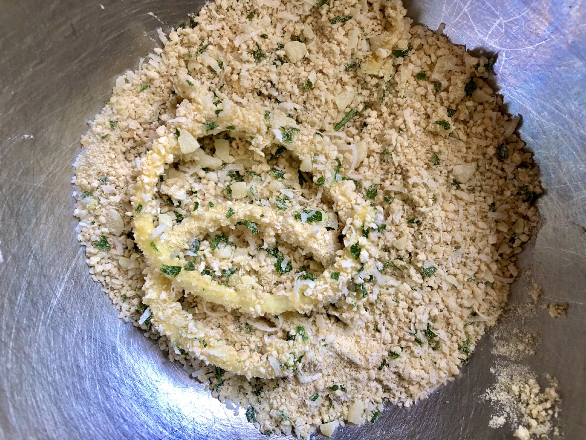 Dredging zucchini in panko bread crumbs