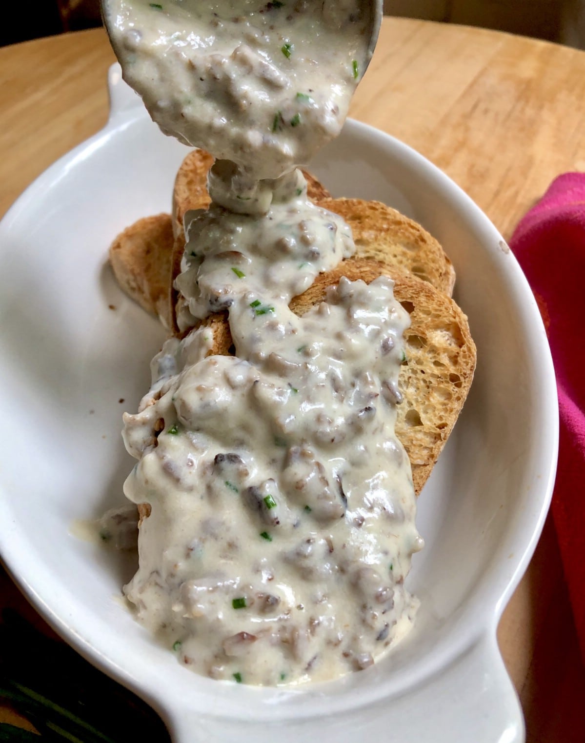 Pouring creamy chipped beef over toast