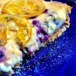 Blueberry cheesecake slice on blue plate
