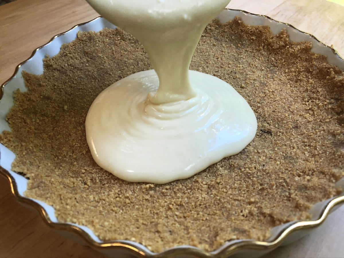 Pouring cheesecake into crust