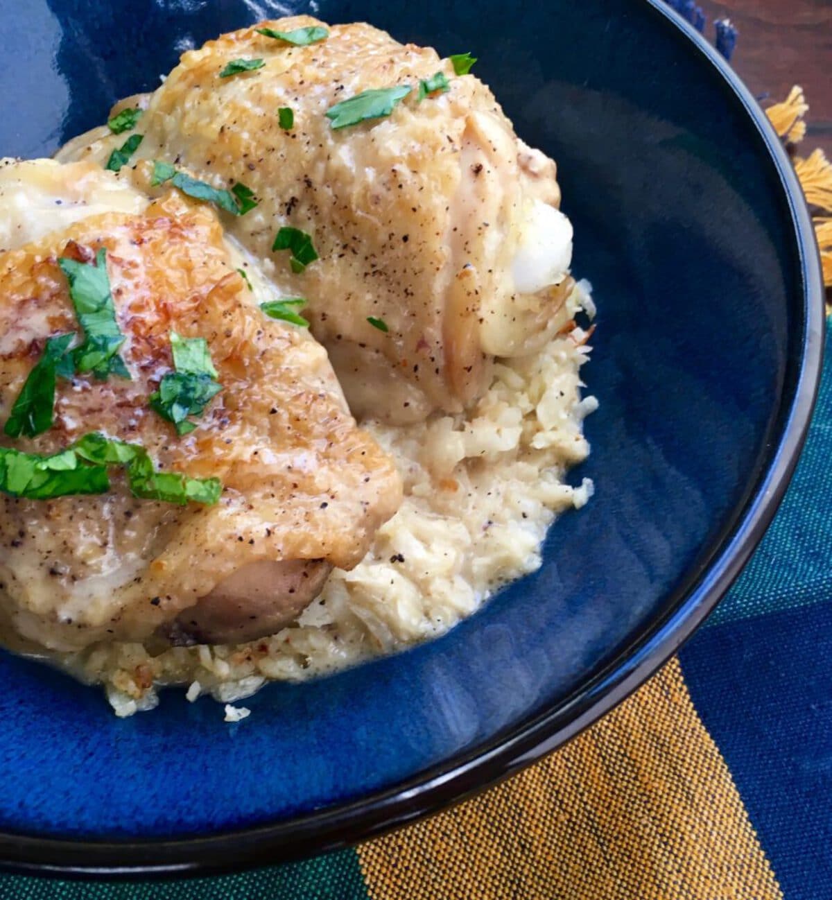 Chicken on bed of rice on blue plate