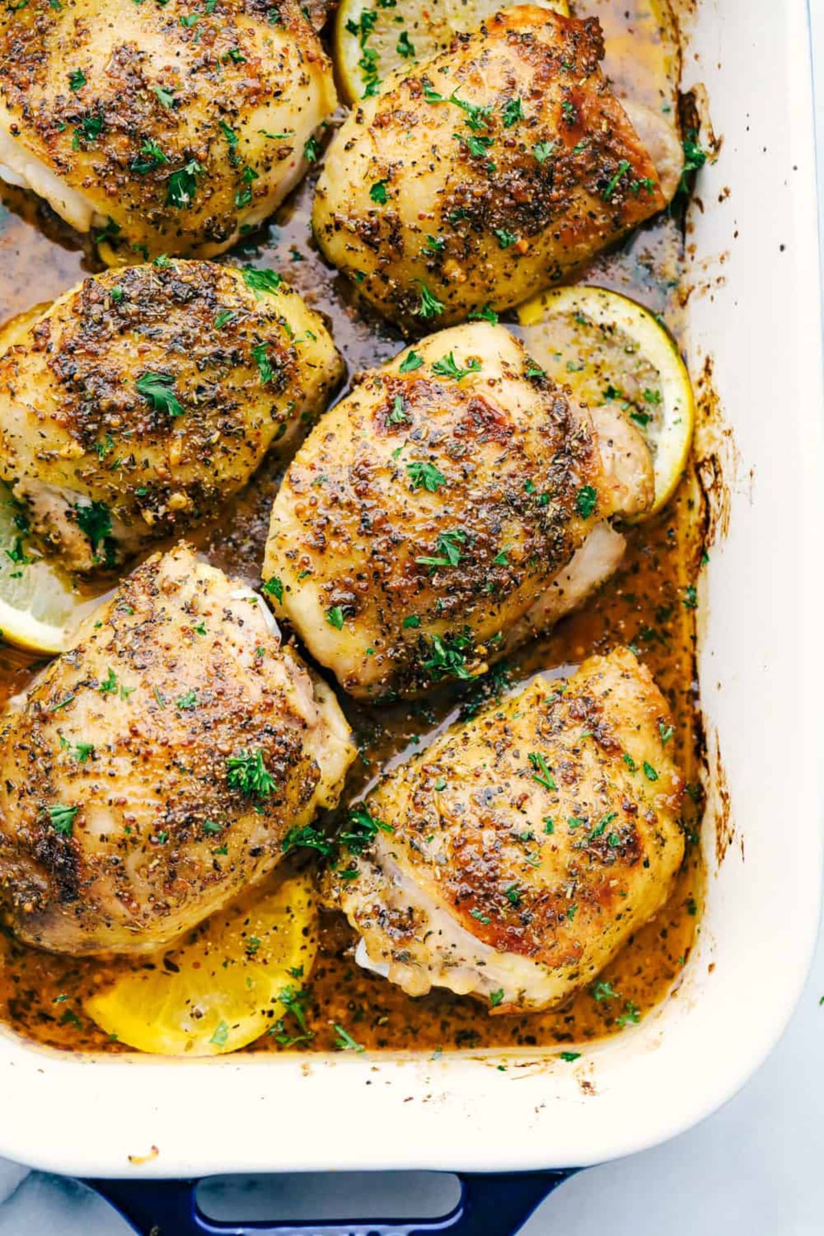 Chicken thighs with lemon in baking dishes