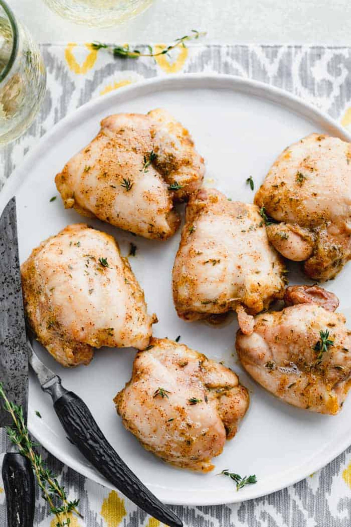 Chicken thighs on white plate